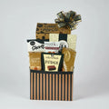 Gift basket with various snacks and treats on a wooden surface