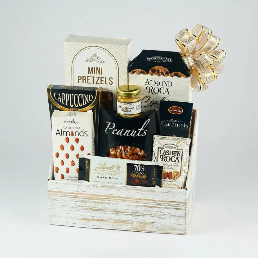 Gift basket with assorted snacks and treats in a wooden box on a white background