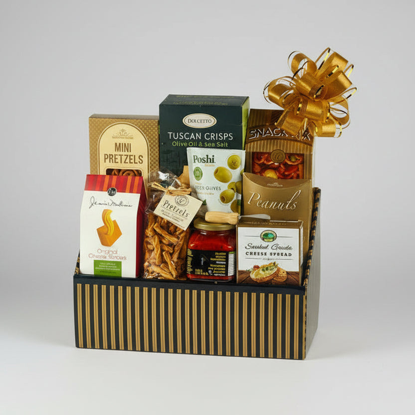 Gourmet gift basket with various snacks and a gold bow on a white background